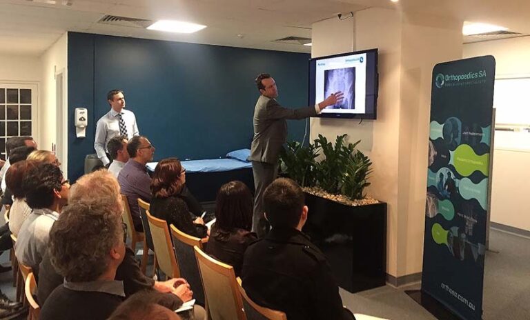 Orthopaedic specialist explaining X-ray findings during the general practitioner event