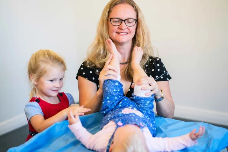 Orthopaedic specialist evaluating mobility in young patient's legs