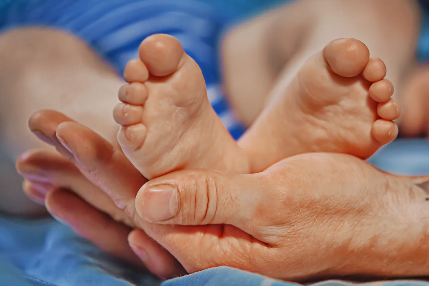 Close-up of infant's feet being examined by orthopaedic specialist