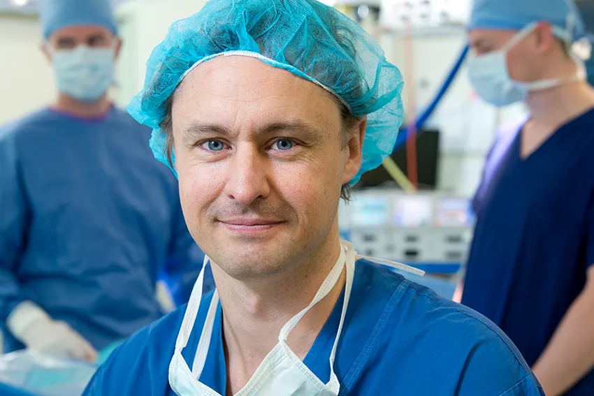 Orthopaedic surgeon using a model to demonstrate the function of a knee joint