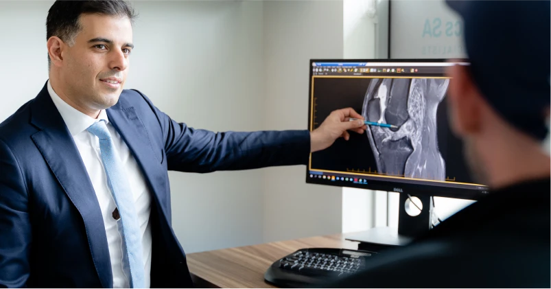 Orthopaedic specialist discussing X-ray results with a patient